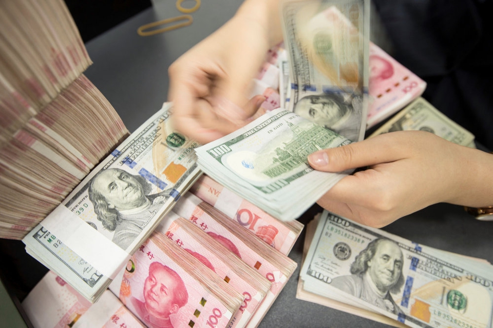 USA beskylder ikke længere Kina for at fuske med sin valuta. Mandag har det amerikanske finansministerium således fjernet betegnelsen valutamanipulator, som USA officielt hæftede på Kina i august 2019. Her ses en ansat i en kinesisk bank tælle yuan og dollarsedler. (Arkivfoto).